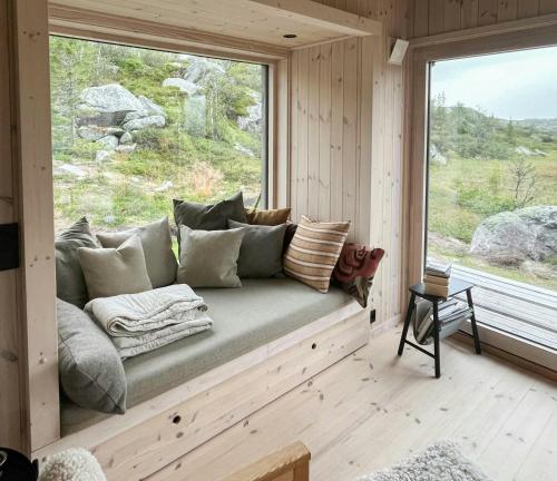 a couch sitting in a room with a window at Architect-Designed Cabin With Views Of Sigdal in Skadeland