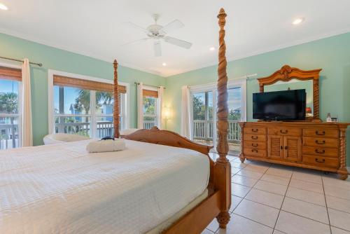 a bedroom with a bed and a television on a dresser at Cape Palms in Port Saint Joe