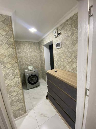a bathroom with a tub and a toilet in it at Ruslan Hotel 1 in Poti
