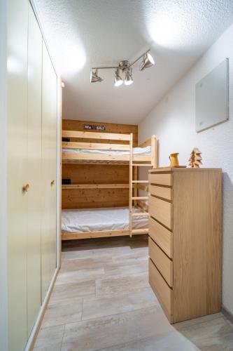 a bedroom with two bunk beds and a dresser at Valloire Center in Valloire