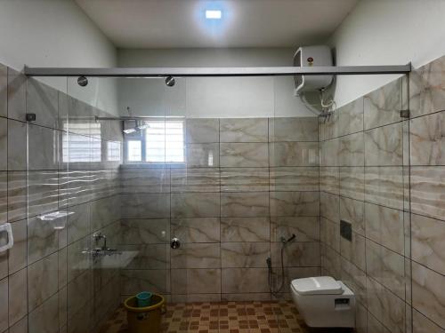 a bathroom with a shower and a toilet at Richmount Natural Resort Private Limited in Salem