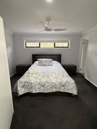a bedroom with a bed and a window at New House in Beaufort in Beaufort