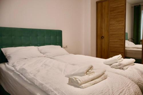 a bed with white towels on top of it at Casa Centrale with Free Parking in Plovdiv