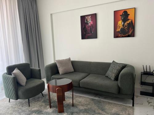 a living room with a couch and a chair at Marina Al Hamra in Ras al Khaimah