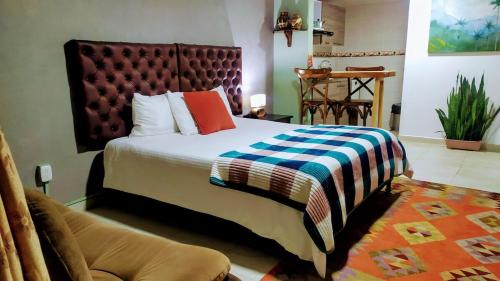 a bedroom with a large bed with a blanket on it at mini loft apart studio Salento in Salento