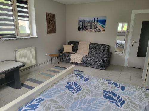 a living room with a bed and a couch at Panorama Widok in Ostróda