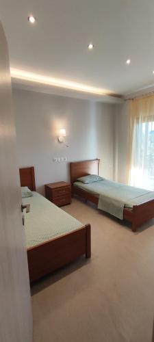 a bedroom with two beds and a window at House Evristhenis 1 in Toroni