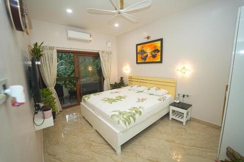 a bedroom with a bed and a ceiling fan at GGH - Ocean Nest, Goa in Candolim