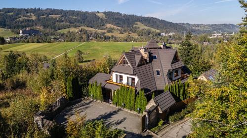 an aerial view of a house with a fence at Delta House in Zakopane