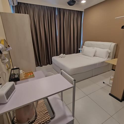 a small room with a bed and a window at Urban Suites JSW GEORGETOWN PENANG, MALAYSIA in Jelutong