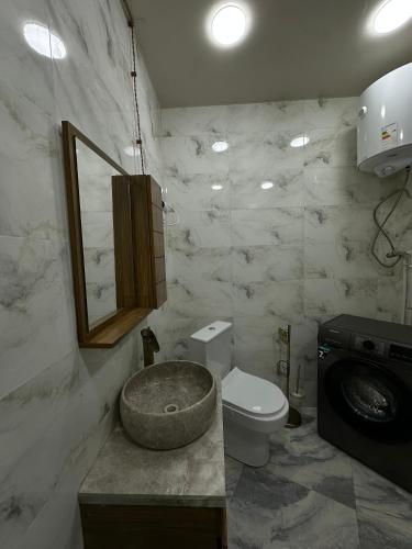 a bathroom with a toilet and a sink at GR Qobu merisi in Inasharidzeebi
