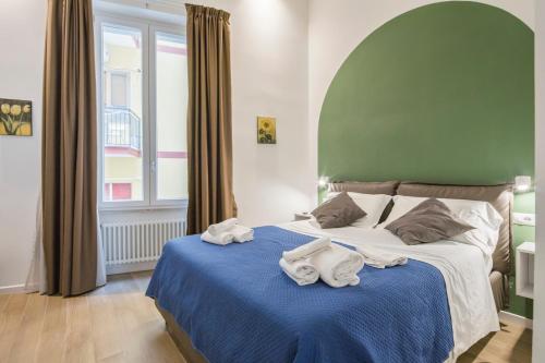 a bedroom with a bed with towels on it at Palazzo Olimpia - Luxury Retreat in Salerno