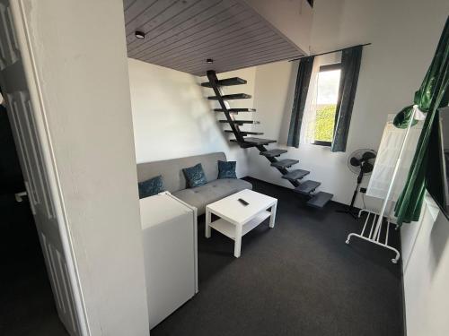 a room with a couch and a spiral staircase at Zoon on in Costinesti