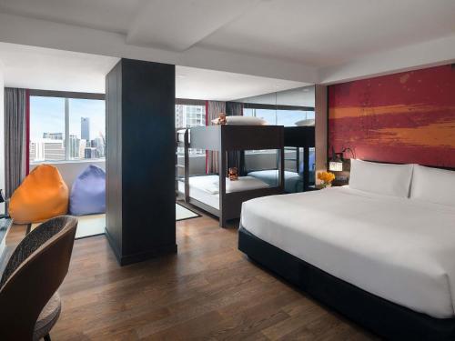 a hotel room with a bed and a view of a city at Mercure Bangkok Sukhumvit 11 in Bangkok