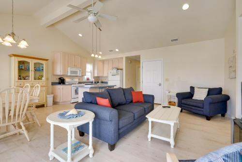 a living room with a blue couch and a table at Ocean City Family Getaway about Qtr-Mi to Beach! in Ocean City