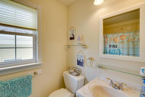a bathroom with a toilet and a sink and a window at Ocean City Family Getaway about Qtr-Mi to Beach! in Ocean City