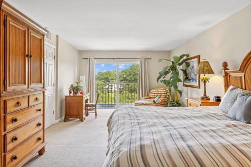 a bedroom with a bed and a dresser and a window at 891 Ketch Court in Hilton Head Island