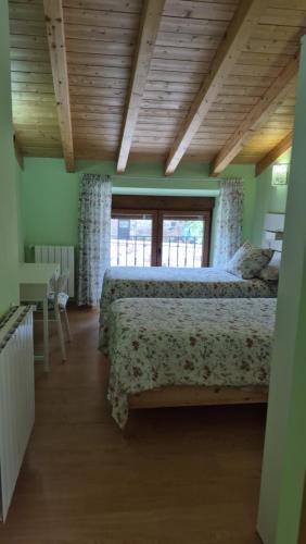 a bedroom with a bed and a large window at La Posada De Faustina in Naveda