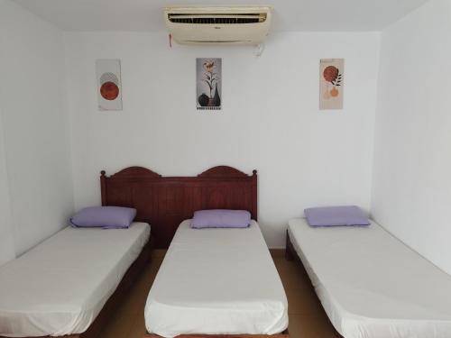two twin beds in a room with a heater at MARIA HOSTEL FOREIGNERS ONLY-CRISS RESORT-NAAMA BAY-CITY CeNTER in Sharm El Sheikh
