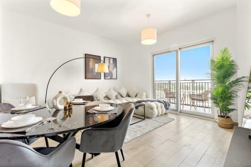 a living room with a table and a couch at FIRST CLASS 2BR Yas Island Living in Abu Dhabi
