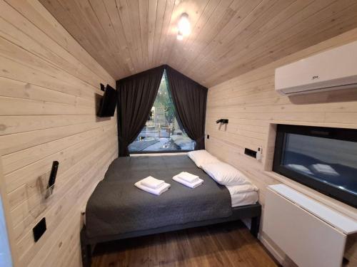 a small bedroom with a bed in a tiny house at SmartVille Kyiv in Kyiv