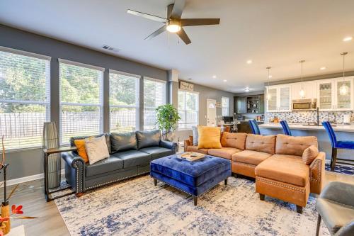 a living room with couches and chairs and a ceiling fan at Airport Home in Union City