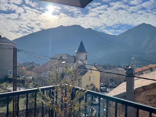 a view from a balcony of a town with a church at L'Idylle avec accès toit terrasse in Veynes