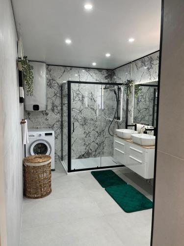 a bathroom with a sink and a washing machine at Villa Lyra in Trogir