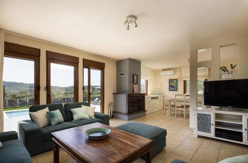 a living room with a couch and a table at Olive Garden Villa Chania in Chania