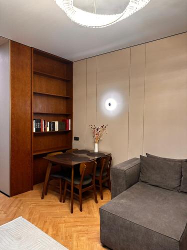 a living room with a table and a couch at Экспо резиденция in Astana