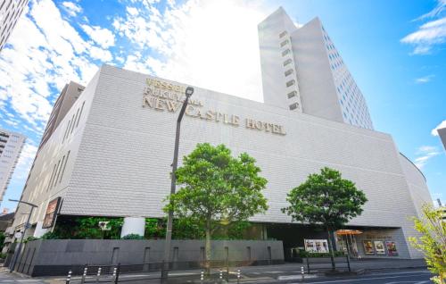 a large white building with a sign on it at Fukuyama New Castle Hotel in Fukuyama