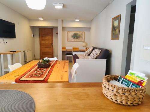 a living room with a table and a couch at Departamento Costa Ramayon in San Martín de los Andes