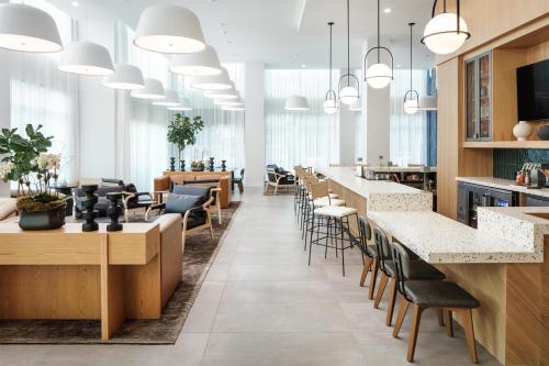 a lobby of a restaurant with tables and chairs at Embassy Suites By Hilton Chattanooga Downtown in Chattanooga