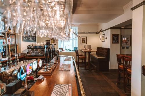 a bar in a pub with a chandelier at Eagle and Child, Ramsbottom in Bury