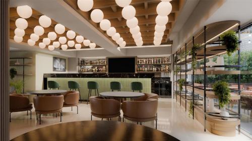 a restaurant with tables and chairs and a bar at Hilton Garden Inn Mexico City Polanco in Mexico City