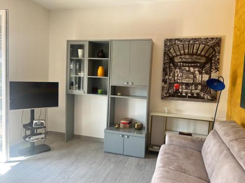 a living room with a couch and a tv at TheSun in Legnano