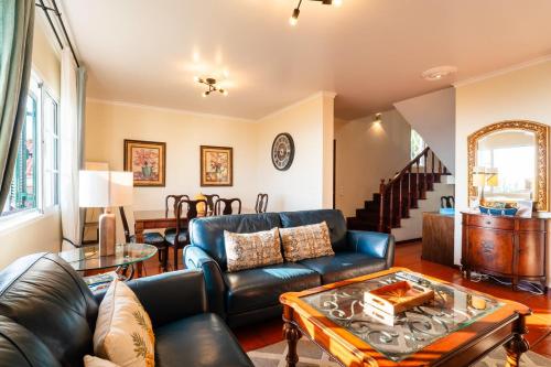 a living room with a couch and a table at GuestReady - Sea-View Retreat in Madeira in Santo António
