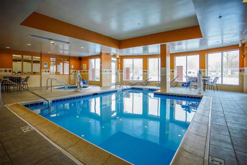 a large swimming pool with blue water in a building at Wyndham Garden Kankakee in Kankakee