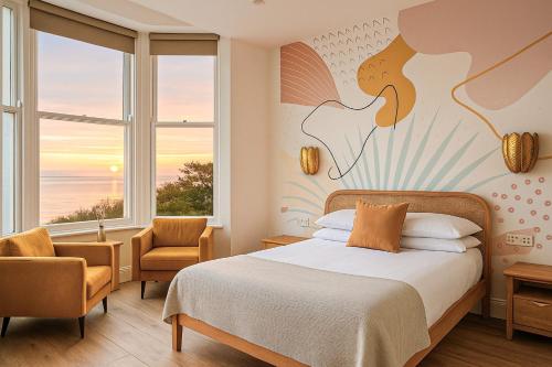 a bedroom with a bed and a large window at Beach House in Scarborough