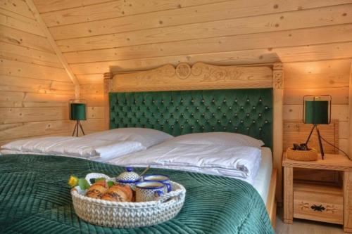 a bedroom with a bed with a basket of bread at Widokówka Kluszkowce in Kluszkowce