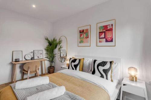a bedroom with a bed and a desk with a chair at Castle Post in Norwich