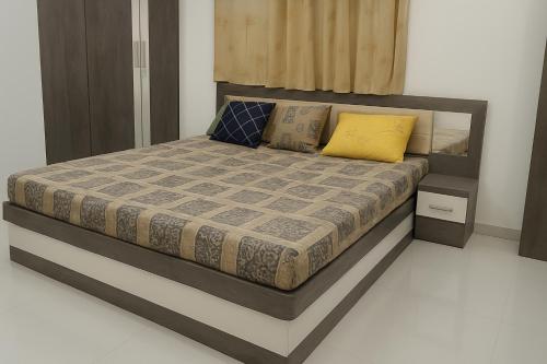 a bedroom with a bed with two pillows on it at Matra Chhaya farmhouse in Nāna