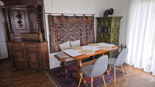 a dining room with a wooden table and chairs at Zum Waldschlössl im Vilstal in Aldersbach