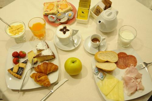 a table with two plates of breakfast food on it at Santorsola Relax Hotel in Sant’Orsola