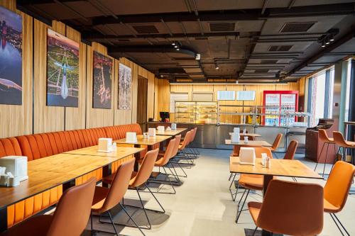 a restaurant with wooden tables and chairs and a counter at Keruen inn Merke in Aktokan