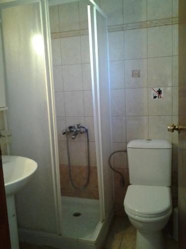 a bathroom with a shower and a toilet and a sink at Windy Place in Fourfourás