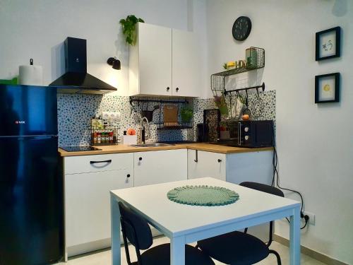 a kitchen with a white table and a blue refrigerator at Zmaj 16 in Divčibare