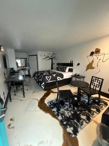 a bedroom with a bed and a table and a piano at Southern Soho Boutique Hotel in Oxford