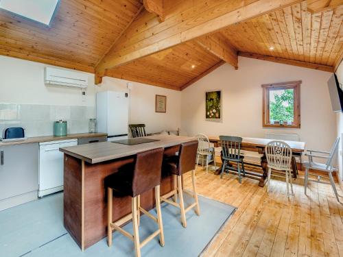 a kitchen and dining room with a wooden ceiling at Mayfield Lodge - Uk39917 in Heckington