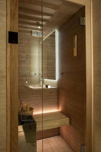 a bathroom with a shower with a glass door at Casa Allegra - luxury apartment in the centre of Pietrasanta in Pietrasanta